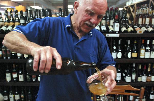 Carl Raskin pours a craft beer during a recent tasting at his elegance wine and antiques shop in Grants Pass, Ore. Craft brews are the fastest-growing segment of the beer industry.