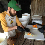 Head Brewer Garrett Crowell cutting kumquats